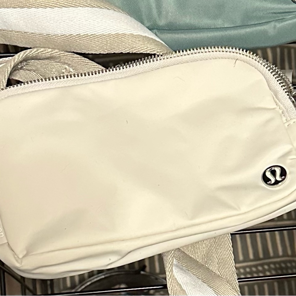 Lululemon cream crossbody bag with striped strap NWT